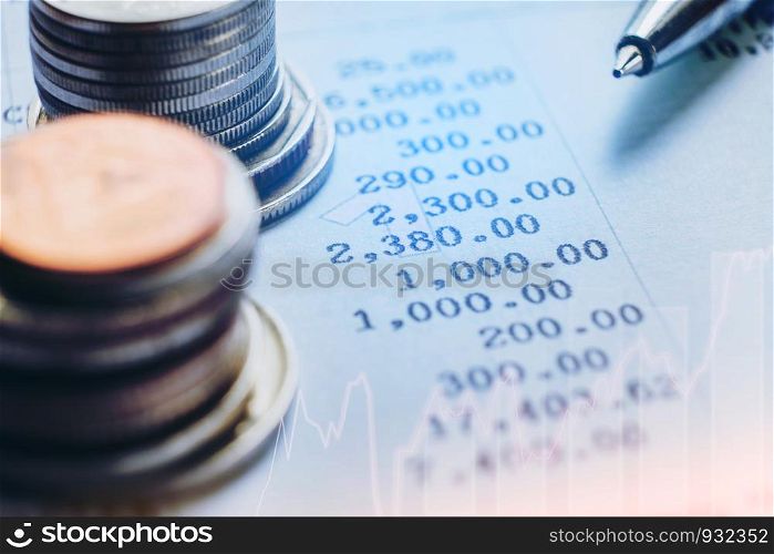 financial analyzing concept Pen and coin and on paper report.