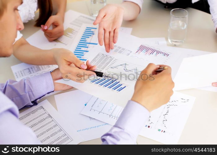 financial and business documents on the table and human hands