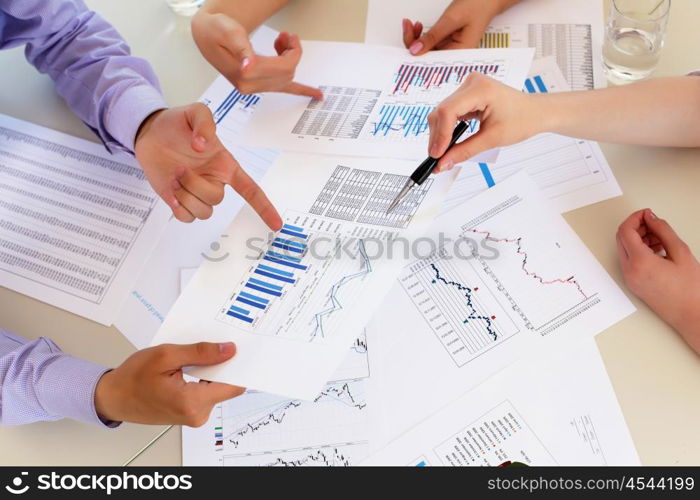 financial and business documents on the table and human hands