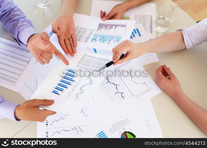 financial and business documents on the table and human hands