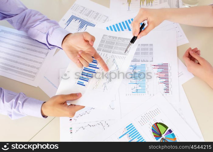 financial and business documents on the table and human hands