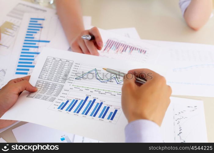 financial and business documents on the table and human hands