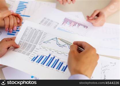 financial and business documents on the table and human hands