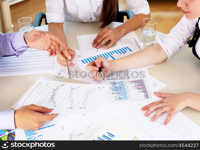 financial and business documents on the table and human hands