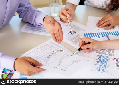 financial and business documents on the table and human hands