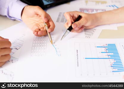 financial and business documents on the table and human hands