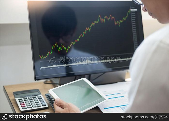 Financial broker looking at the statistics of stock exchange and discussing on computer monitor, Business Investment Entrepreneur Trading Concept