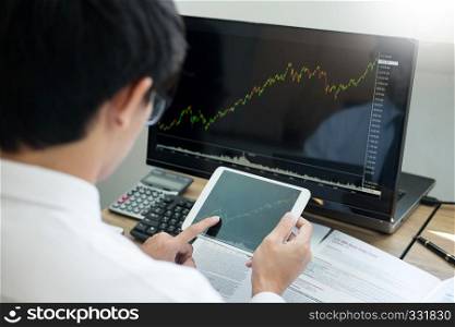 Financial broker looking at the statistics of stock exchange and discussing on computer monitor, Business Investment Entrepreneur Trading Concept