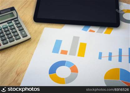 financial chart with calculator and digital tablet