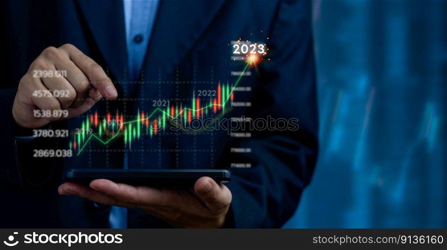financial charts and graph analysis marketing showing growing revenue In 2023 floating above digital screen phone, business about strategy for growth and success.graph and indicator candlestick.