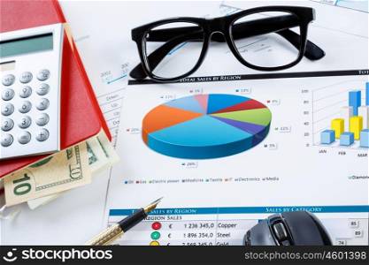 Financial charts and graphs on the table. financial charts and graphs and glasses on the office table