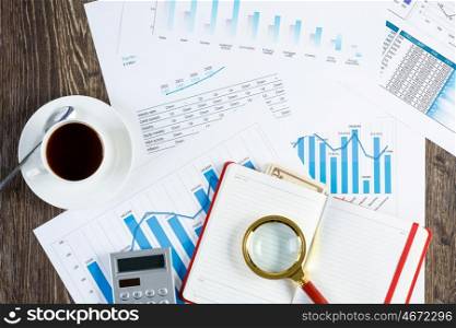 Financial charts and graphs on the table. financial charts and graphs and a cup of coffee