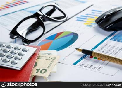 Financial charts and graphs on the table. financial charts and graphs and glasses on the office table