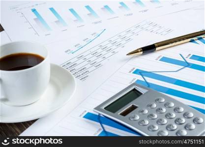Financial charts and graphs on the table. financial charts and graphs and a cup of coffee