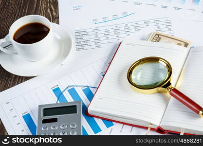 Financial charts and graphs on the table. financial charts and graphs and a cup of coffee