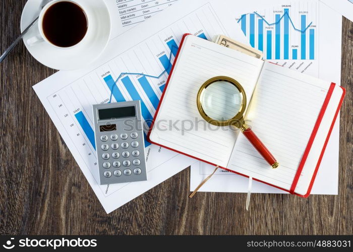 Financial charts and graphs on the table. financial charts and graphs and a cup of coffee