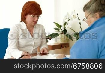 Financial consultant presents bank investments to mature woman