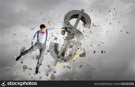 Financial crisis concept. Emotional businessman breaking with anger stone dollar symbol