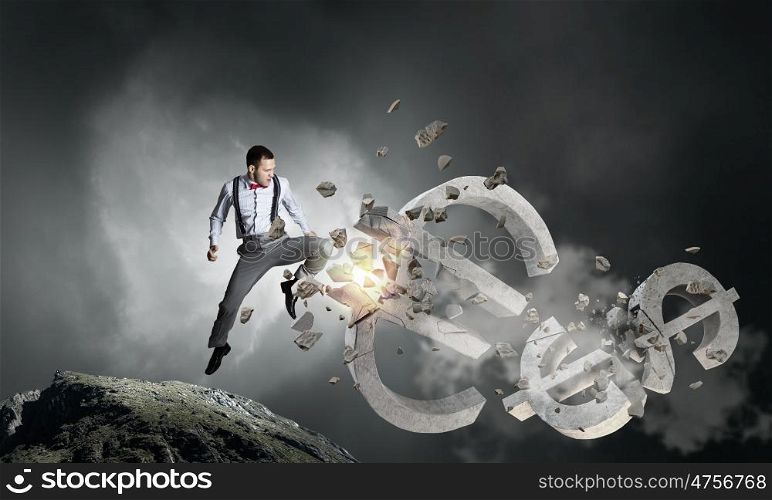 Financial crisis concept. Emotional businessman breaking with hand stone euro symbol