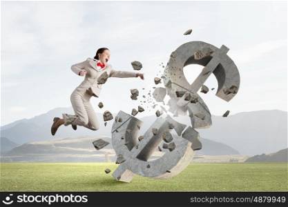 Financial crisis concept. Emotional businesswoman breaking with hand stone dollar symbol