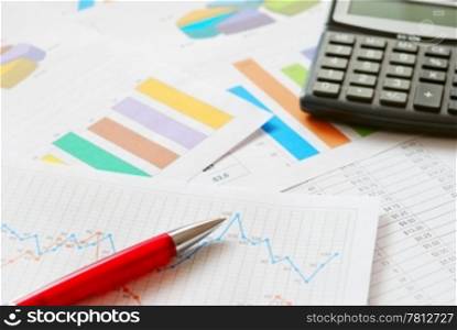 Financial documents with red pen and calculator. Financial documents