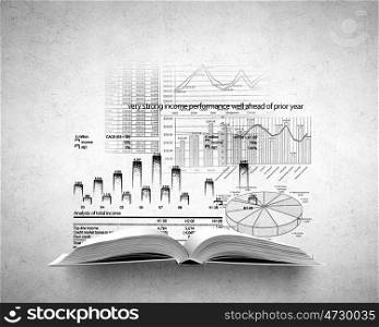 Financial education concept. Old opened book with infograph sketches over concrete background