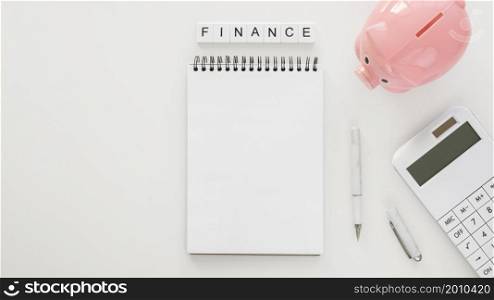 financial elements arrangement with empty notepad