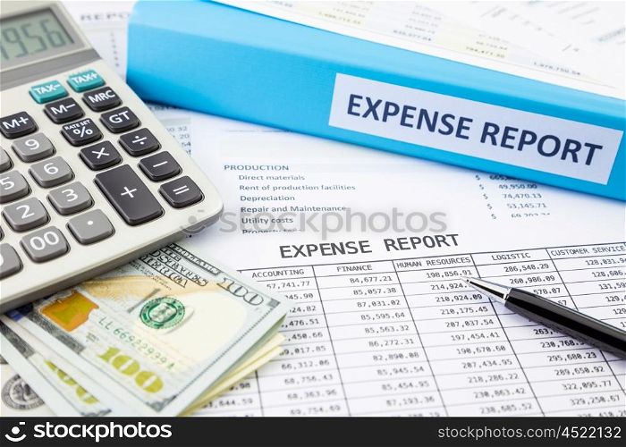 Financial expense report with banknotes and calculator