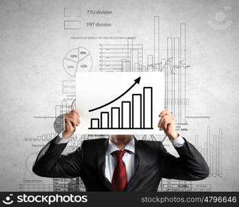 Financial growth and income. Businessman hiding his face behind paper sheet with growth concept