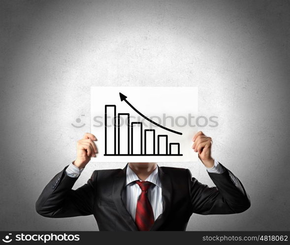 Financial growth and income. Businessman hiding his face behind paper sheet with growth concept