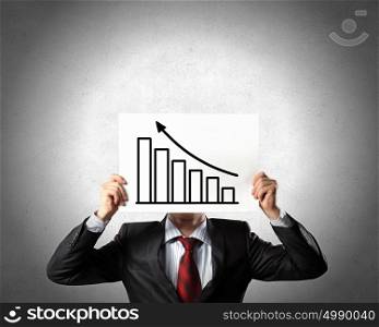 Financial growth and income. Businessman hiding his face behind paper sheet with growth concept