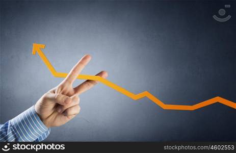 Financial growth and income concept. Hand cutting with fingers rising arrow representing business growth