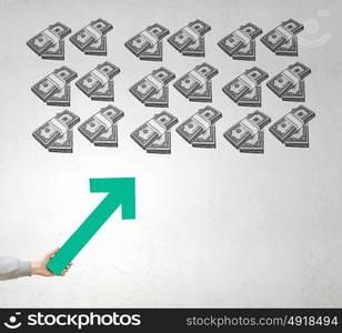 Financial growth and increase. Hand holding arrow representing business growth concept