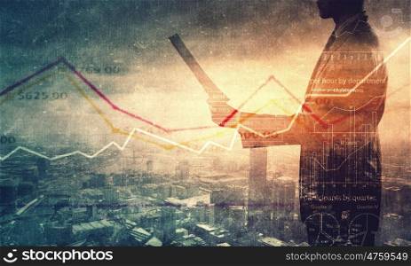 Financial growth. Back view of businessman and graphs at background
