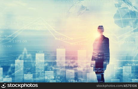 Financial growth. Back view of businesswoman and graphs at background