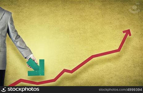 Financial growth. Hand holding arrow representing business growth concept