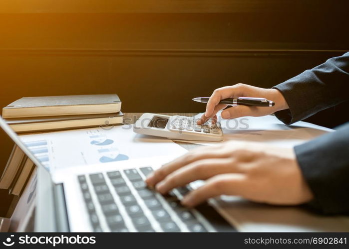 financial inspector executive calculating on investment data with documents and laptop