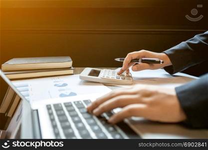 financial inspector executive calculating on investment data with documents and laptop