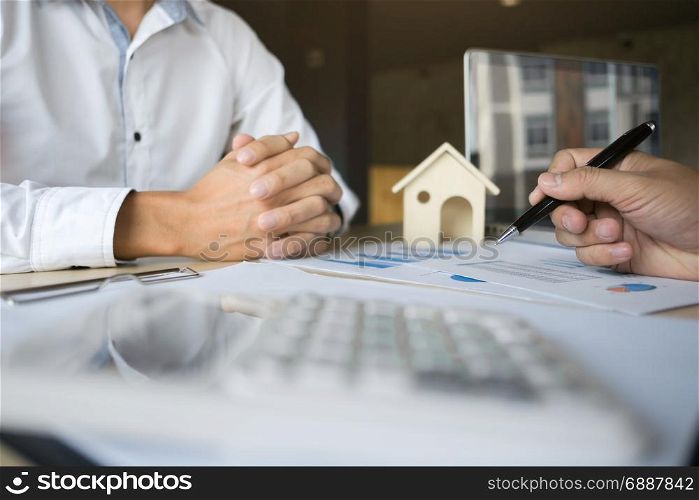 financial inspector making report,insurance agent analyzing about home investment loan at office room