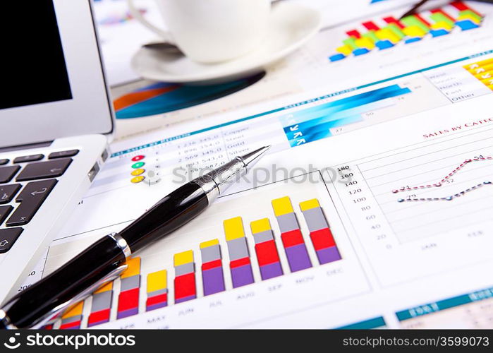 Financial paper charts and graphs on the table