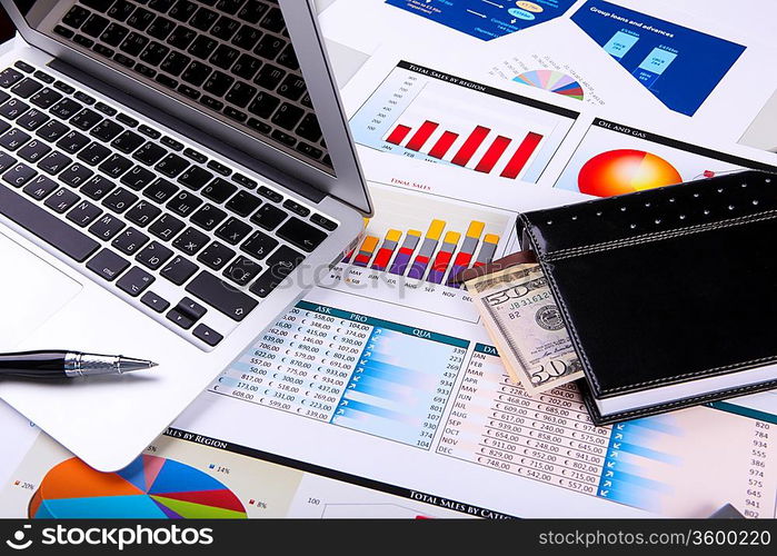 Financial paper charts and graphs on the table