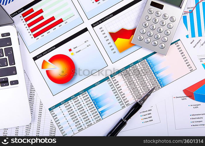 Financial paper charts and graphs on the table