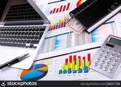 Financial paper charts and graphs on the table