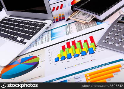 Financial paper charts and graphs on the table