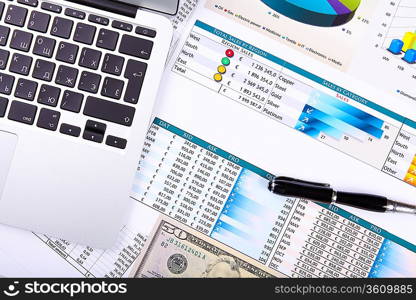 Financial paper charts and graphs on the table