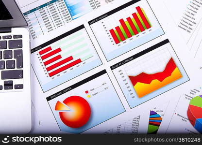 Financial paper charts and graphs on the table