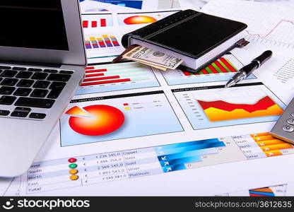 Financial paper charts and graphs on the table