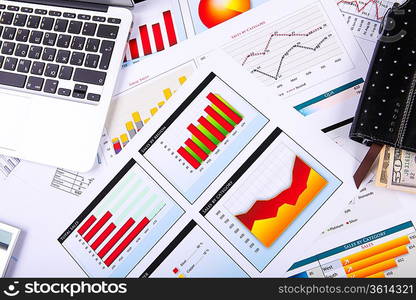 Financial paper charts and graphs on the table