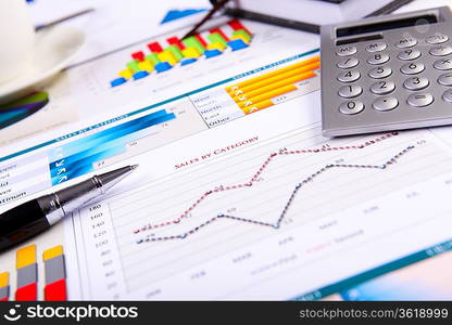 Financial paper charts and graphs on the table