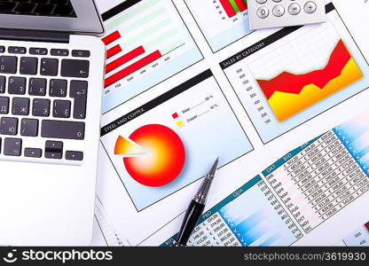 Financial paper charts and graphs on the table